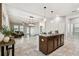 Open-concept kitchen with modern appliances, island, and seamless flow into the living area at 21284 Southern Charm Dr, Land O Lakes, FL 34637