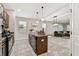 Spacious kitchen with an island featuring stone countertops and open layout to the living area at 21284 Southern Charm Dr, Land O Lakes, FL 34637