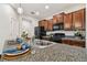 Granite kitchen island featuring a double sink and room for seating at 21284 Southern Charm Dr, Land O Lakes, FL 34637