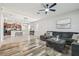 Open concept living space showcases a modern sectional and seamless flow to the kitchen at 21284 Southern Charm Dr, Land O Lakes, FL 34637