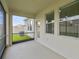 Screened-in lanai with large windows showcasing the green backyard at 21284 Southern Charm Dr, Land O Lakes, FL 34637