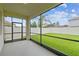 This screened patio offers a serene view of the lush, green backyard, perfect for outdoor relaxation at 21284 Southern Charm Dr, Land O Lakes, FL 34637