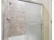 Shower with gray tiled walls and sliding glass door at 21284 Southern Charm Dr, Land O Lakes, FL 34637