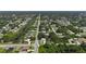 An aerial view showcases a residential neighborhood with lush greenery, waterways, and tree-lined streets, offering a serene community setting at 21426 Quesada Ave, Port Charlotte, FL 33952