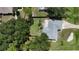 Overhead view of a home with a fenced yard, driveway, and lush greenery surrounding the property at 21426 Quesada Ave, Port Charlotte, FL 33952