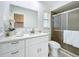 Updated bathroom features a white vanity with quartz countertop and walk-in shower at 21426 Quesada Ave, Port Charlotte, FL 33952