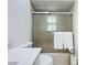Close-up of tiled shower with sliding glass doors, and clean white vanity at 21426 Quesada Ave, Port Charlotte, FL 33952