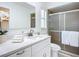 Updated bathroom features a white vanity with quartz countertop and walk-in shower at 21426 Quesada Ave, Port Charlotte, FL 33952