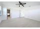 Large bedroom boasts light floors, a ceiling fan, and an ensuite bathroom at 21426 Quesada Ave, Port Charlotte, FL 33952