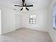 This bright, neutral bedroom features light floors, a ceiling fan, and closet space at 21426 Quesada Ave, Port Charlotte, FL 33952