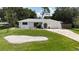 Charming single-story home with a well-maintained lawn, driveway, and a one-car garage at 21426 Quesada Ave, Port Charlotte, FL 33952