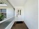 Front door entryway featuring a white door with windows, with a black welcome mat on stone at 21426 Quesada Ave, Port Charlotte, FL 33952