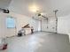 Spacious garage with white walls, sealed floor and overhead door at 21426 Quesada Ave, Port Charlotte, FL 33952