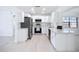 Updated kitchen with stainless steel appliances, quartz countertops, and bright white cabinetry offers a modern cooking space at 21426 Quesada Ave, Port Charlotte, FL 33952