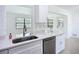The kitchen features white cabinets, stainless appliances, stone countertops, and an undermount sink at 21426 Quesada Ave, Port Charlotte, FL 33952
