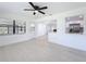 Bright living room with white walls, new floors, and an open layout to the kitchen at 21426 Quesada Ave, Port Charlotte, FL 33952