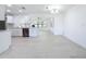 Bright living room open to a modern kitchen with stainless steel appliances and white cabinetry at 21426 Quesada Ave, Port Charlotte, FL 33952