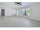 Bright living room with modern light floors, window, and view of entryway at 21426 Quesada Ave, Port Charlotte, FL 33952