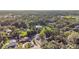 An aerial view showcases the home nestled among lush trees in a quiet neighborhood at 221 S Kingsway Rd, Seffner, FL 33584