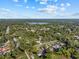 An aerial view showcases the neighborhood, highlighting nearby lake and lush greenery at 221 S Kingsway Rd, Seffner, FL 33584