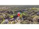 An aerial view showcases the home nestled among lush trees in a quiet neighborhood at 221 S Kingsway Rd, Seffner, FL 33584