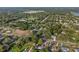 An aerial view of the neighborhood, showcasing community near a lake, interspersed with trees at 221 S Kingsway Rd, Seffner, FL 33584