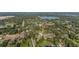 An aerial view of the neighborhood, showcasing community near a lake, interspersed with trees at 221 S Kingsway Rd, Seffner, FL 33584