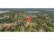 An aerial view shows the house in a lush, established neighborhood close to a lake at 221 S Kingsway Rd, Seffner, FL 33584
