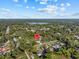 An aerial view showcases the neighborhood, highlighting nearby lake and lush greenery at 221 S Kingsway Rd, Seffner, FL 33584