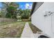 View of side yard with white vinyl siding and sidewalk at 221 S Kingsway Rd, Seffner, FL 33584