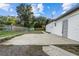 Backyard features a concrete patio area and chain-link fence, with some trees in the distance at 221 S Kingsway Rd, Seffner, FL 33584