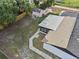 Backyard with an extended patio area, shed, and a mix of green grass and sparse ground cover at 221 S Kingsway Rd, Seffner, FL 33584