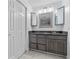 Bathroom featuring dual vanity, granite countertop, and framed mirrors above the sink at 221 S Kingsway Rd, Seffner, FL 33584