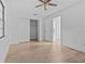Bright bedroom boasting wood floors and an open closet, creating a functional space at 221 S Kingsway Rd, Seffner, FL 33584