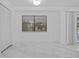 Bright bedroom with white walls and tile floors, and a view of the backyard at 221 S Kingsway Rd, Seffner, FL 33584