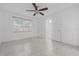 Inviting bedroom boasts neutral tile floors, a stylish ceiling fan, and ample natural light at 221 S Kingsway Rd, Seffner, FL 33584