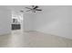 Spacious bedroom featuring neutral tile floors, a ceiling fan, and an ensuite bathroom at 221 S Kingsway Rd, Seffner, FL 33584