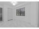 Neutral bedroom featuring white walls, tile floors, and ample natural light at 221 S Kingsway Rd, Seffner, FL 33584