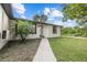 Charming single-story home with a well-maintained lawn, walkway, and a decorative palm tree at 221 S Kingsway Rd, Seffner, FL 33584
