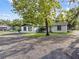 View of the home's front exterior, set in a yard with mature landscaping at 221 S Kingsway Rd, Seffner, FL 33584