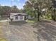 A single-story home with large front yard and mature trees offering shade and curb appeal at 221 S Kingsway Rd, Seffner, FL 33584