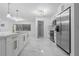 Bright, open kitchen featuring a large island, stainless steel appliances, and marble flooring at 221 S Kingsway Rd, Seffner, FL 33584