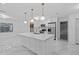 Modern kitchen with white cabinets, stainless steel appliances, and marble countertops at 221 S Kingsway Rd, Seffner, FL 33584