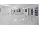 Open concept living space with white cabinets, island, modern lighting, and tile floors at 221 S Kingsway Rd, Seffner, FL 33584