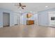 Open-concept living area with neutral walls, tiled floors, and a ceiling fan at 221 S Kingsway Rd, Seffner, FL 33584
