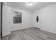 Bright living room featuring stylish gray wood-look flooring and natural light from the window at 221 S Kingsway Rd, Seffner, FL 33584