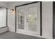 View of covered patio leading to the interior through double doors at 221 S Kingsway Rd, Seffner, FL 33584