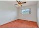 The bedroom features orange carpet, a ceiling fan, and a window with lush green views at 2253 Norwegian Dr # 27, Clearwater, FL 33763