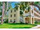 Inviting exterior view of a multi-story building with lush landscaping and a charming architectural design at 2253 Norwegian Dr # 27, Clearwater, FL 33763