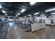 Well-equipped fitness center featuring modern cardio machines, ceiling fans, and a motivating 